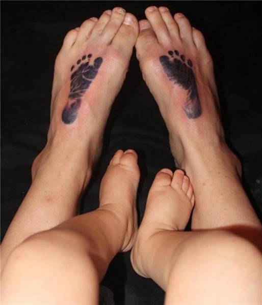 Baby footprints tattoo on feet of a father - Tattoos Book -
