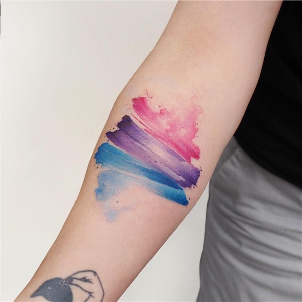 Blue, violet, pink and abstract tattoo on the right forearm