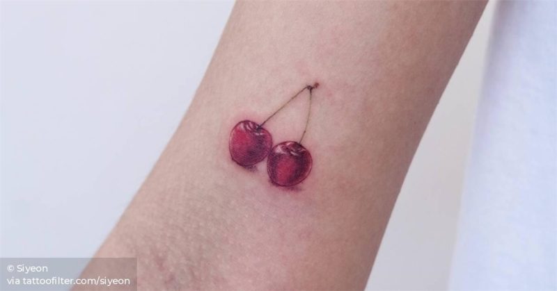 Cherry tattoo on the right bicep.
