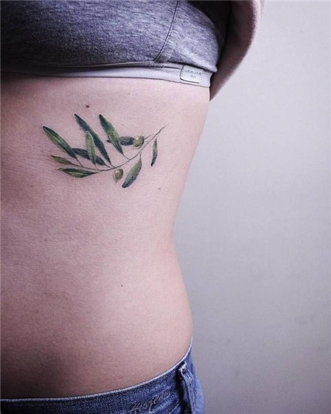 Delicate green olive branch tattoo on the left rib cage Oliv