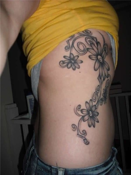 Latest Daisy Flower Tattoo Design Make On Women’s Rib Side