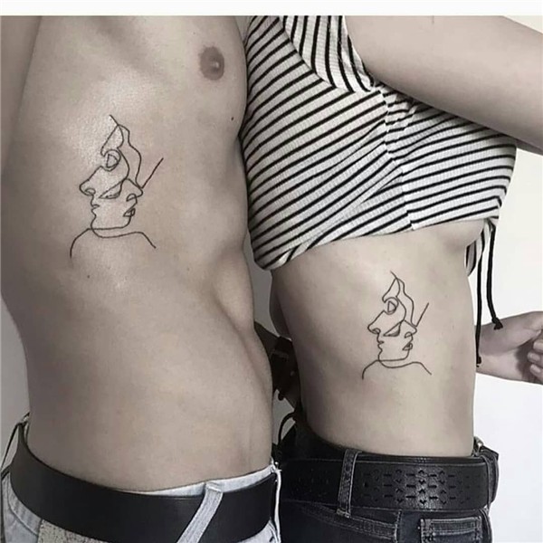 Matching linear faces tattoo on the right rib cages. A perfe