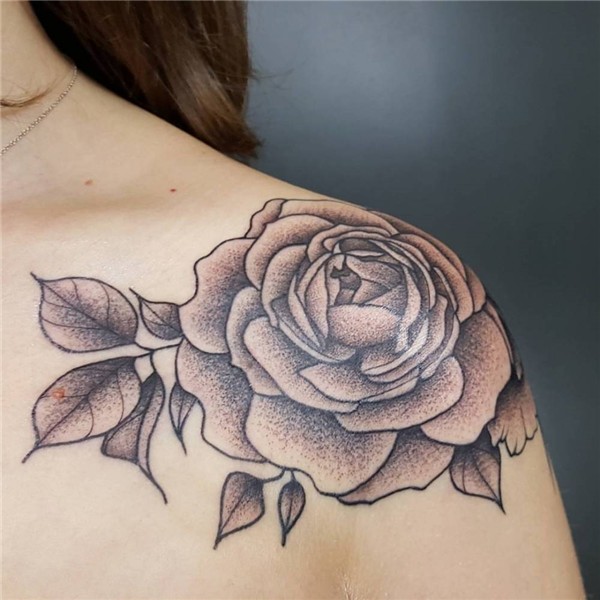 Rose tattoo on the left shoulder.