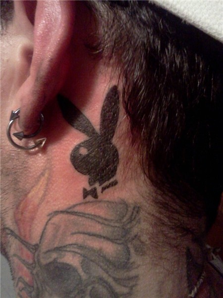Sexy bunny in white playboy tattoo behind ear