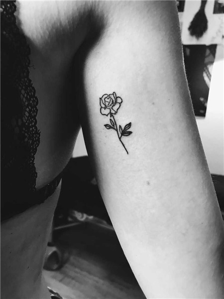 Simple small black rose tattoo on the left upper arm Black r