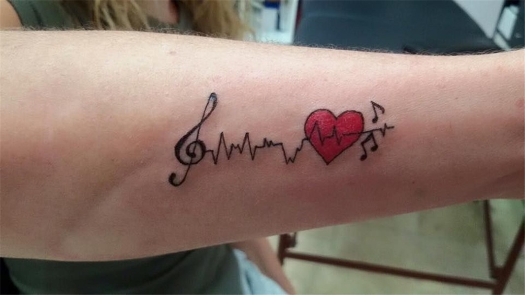 Small Red Heart And Heartbeat With Music Notes Tattoo On Rig
