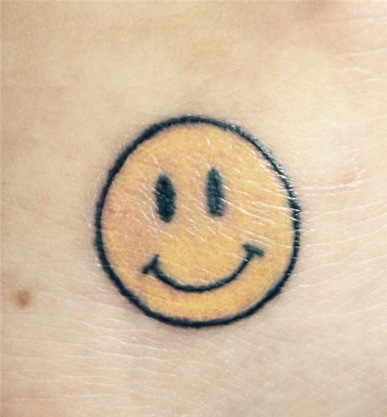 Small smiley tattoo on the foot