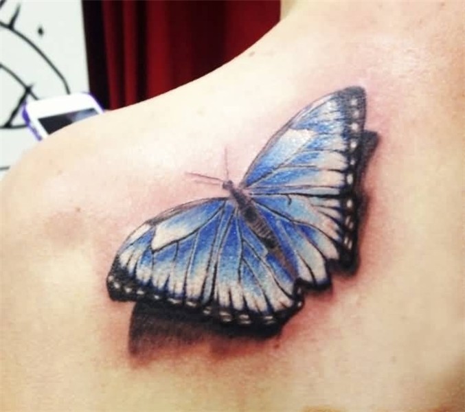 Tattoo Of Brilliant Butterfly Sitting On Women’s Back Should