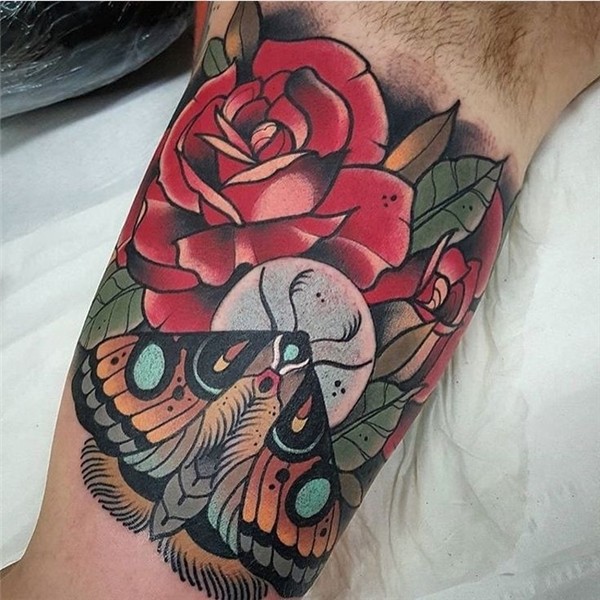 Traditional red roses and moth colored biceps tattoo in old