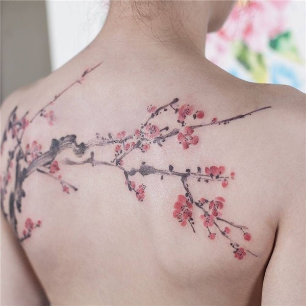 Watercolor cherry blossom tattoo on the upper back. Tatouage