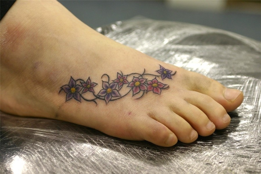 flowers on foot tattoo Tattooed by Johnny at; The Tattoo S.