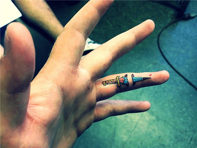 i think its pretty cool sword through finger Finger tattoos,