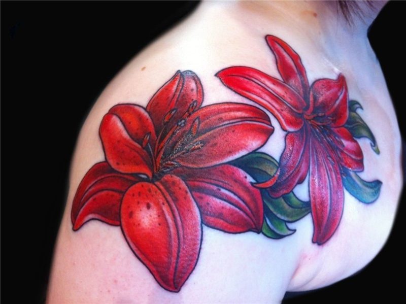 red lily tattoo floral chest piece done by female tattoo art